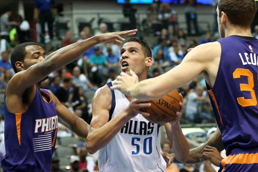 Dallas Mavericks center Salah Mejri (50) attempts a shot as he is defended by Phoenix Suns...
