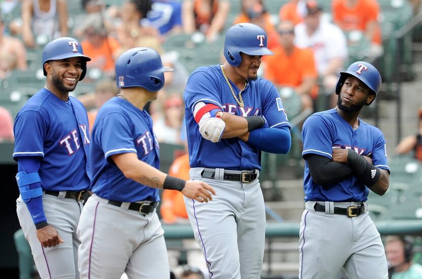 BALTIMORE, MD - JULY 15: Ronald Guzman #67 of the Texas Rangers celebrates with Elvis Andrus...