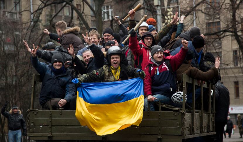 Protesters celebrated the dismissal of President Viktor Yanukovych as they rode through Kiev...