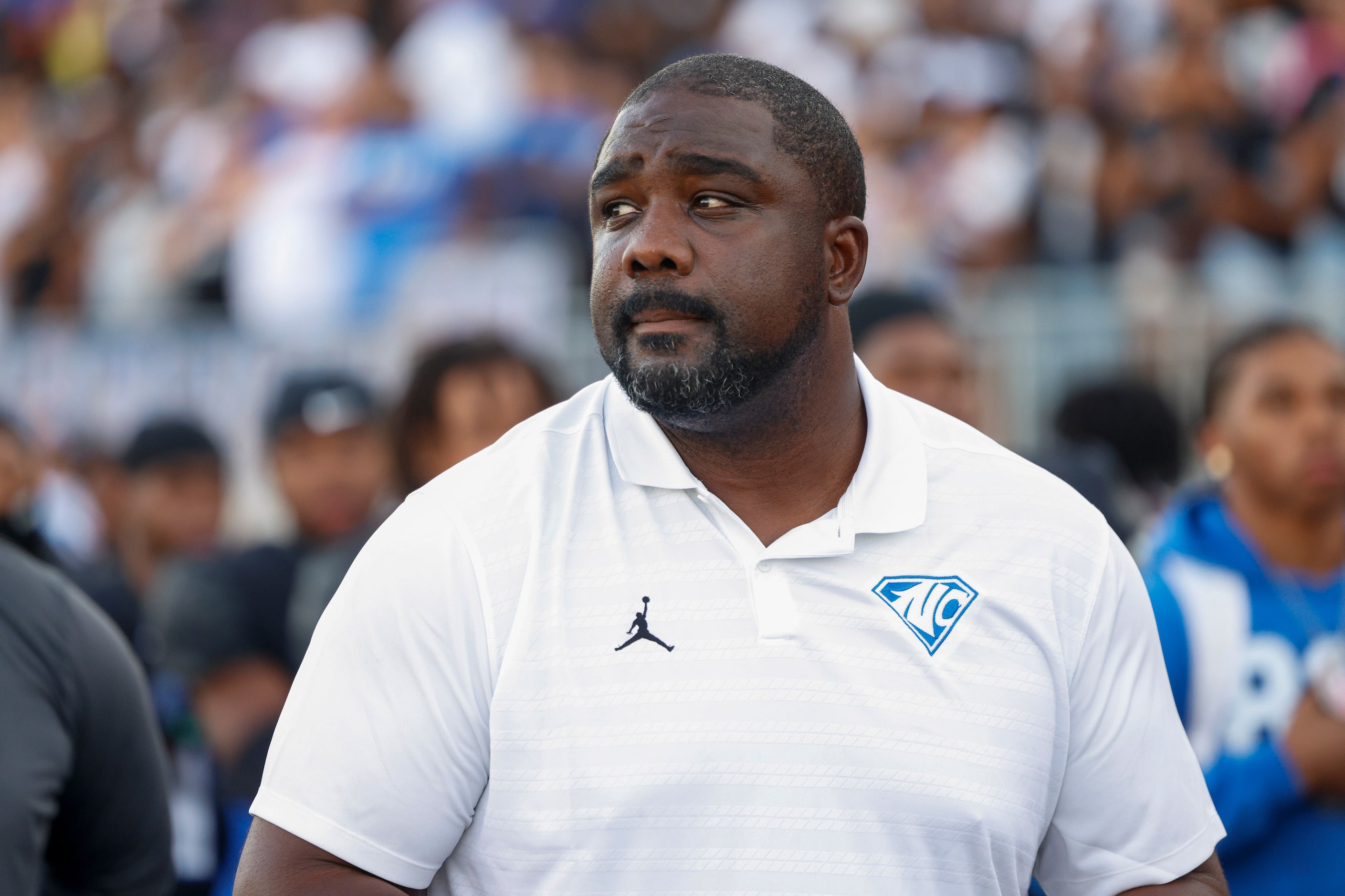 North Crowley head coach Ray Gates stands for the national anthem before a non-district high...