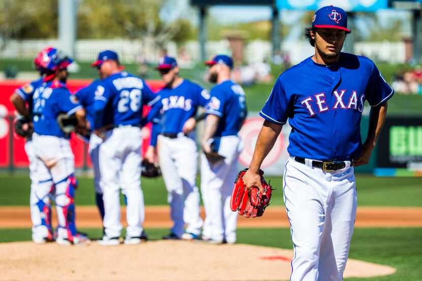 Texas Rangers starting pitcher Yu Darvish (11) walks back to the dugout after being pulled...