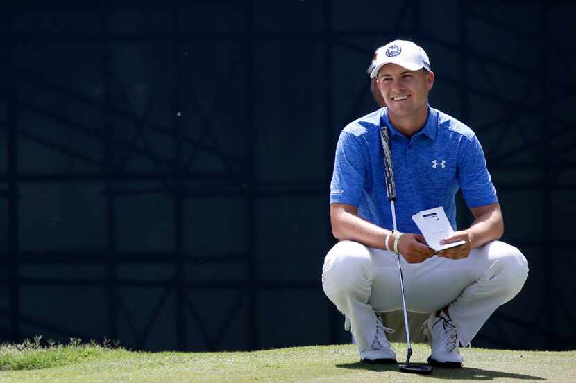 Jordan Spieth smiles as he waits to putt on the 8th hole during Round One of the Dean &...