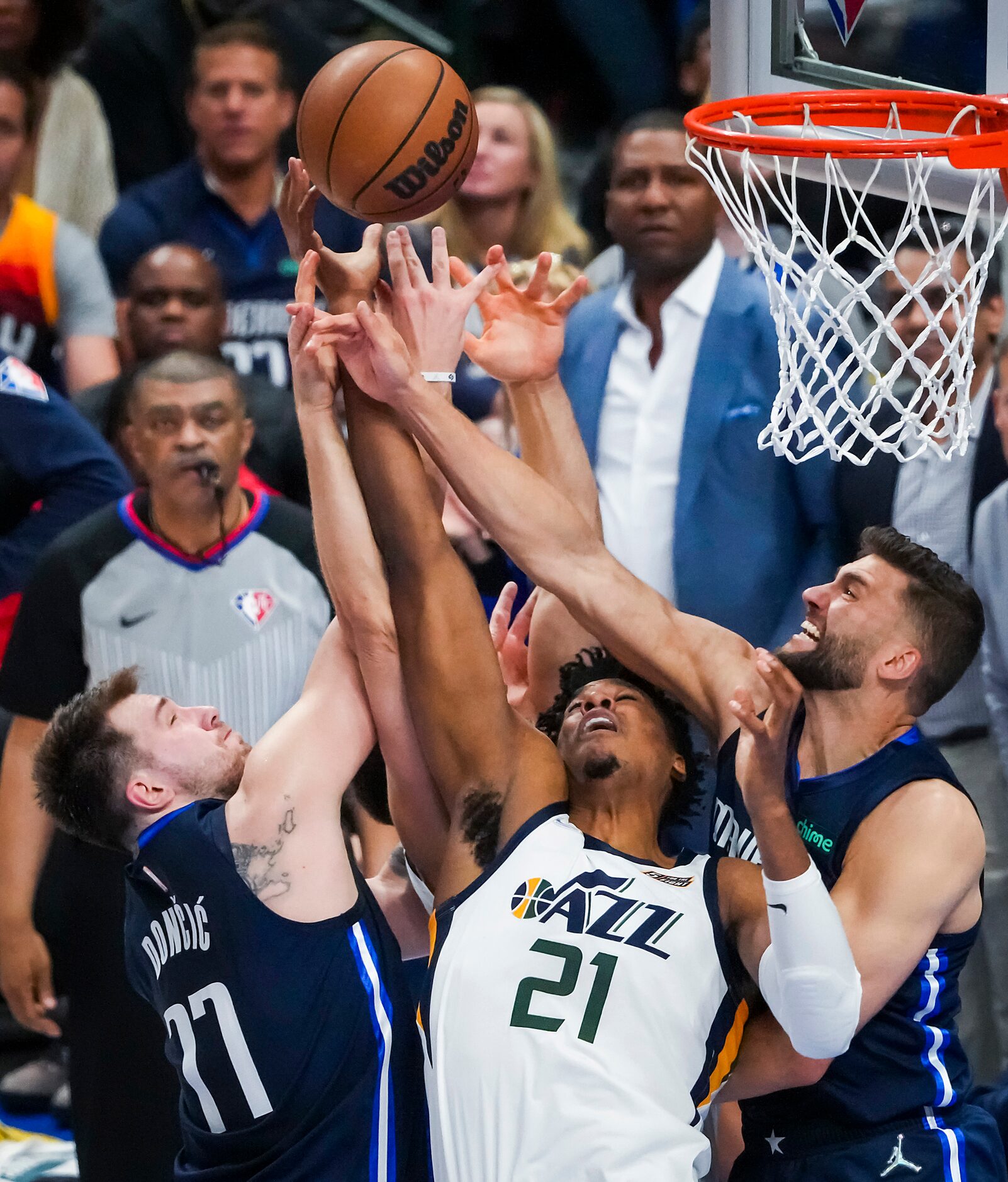 Dallas Mavericks guard Luka Doncic (77) and forward Maxi Kleber (42) fight for a defensive...