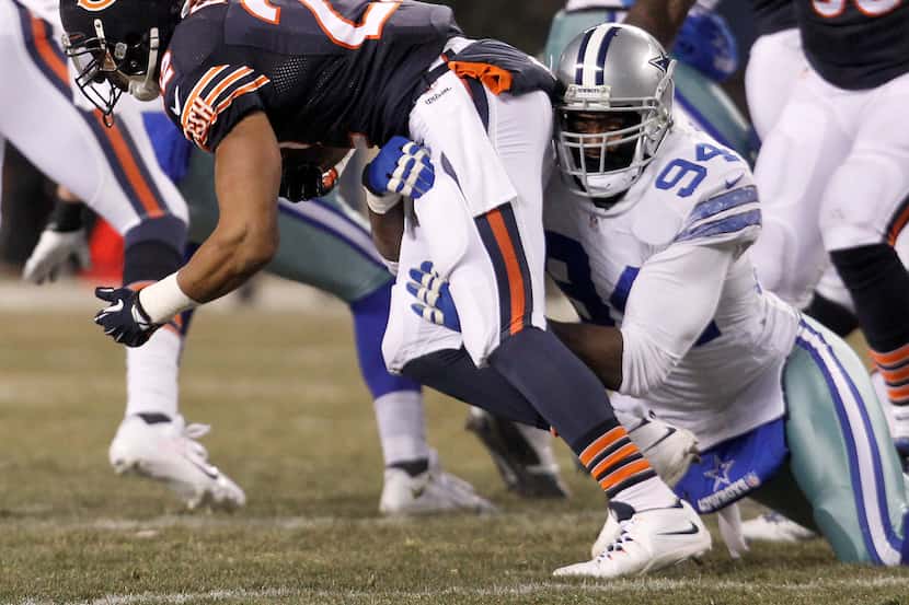 Dallas Cowboys defensive end DeMarcus Ware (94) makes the stop on Chicago Bears running back...