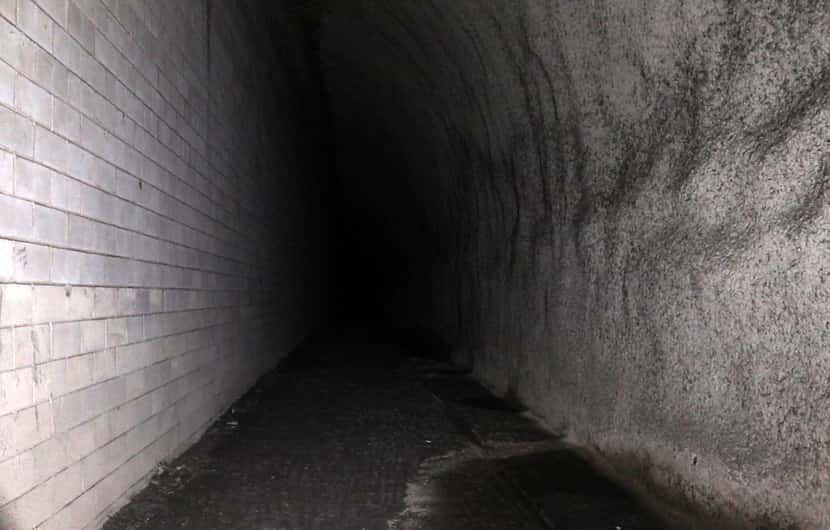 Groundwater seeps into a dark corner of DART's unfinished Knox Street rail station 80 feet...