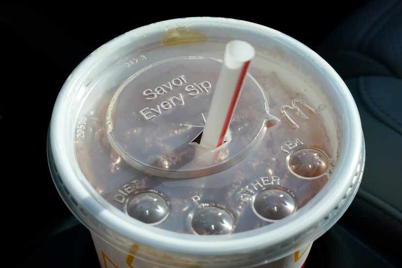A McDonald's beverage sits in a cup holder, April 27, 2021, in Des Moines, Iowa. McDonald's...