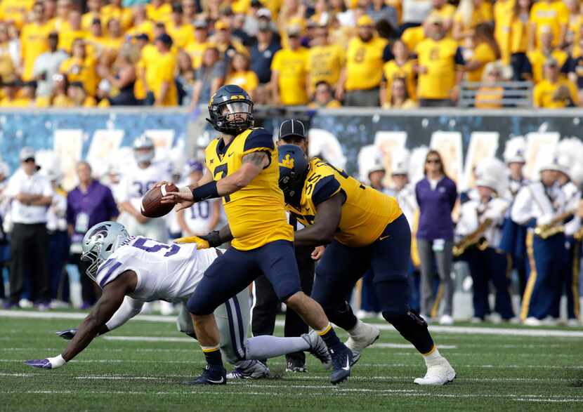 West Virginia quarterback Will Grier (7) pass the ball during the first half of an NCAA...