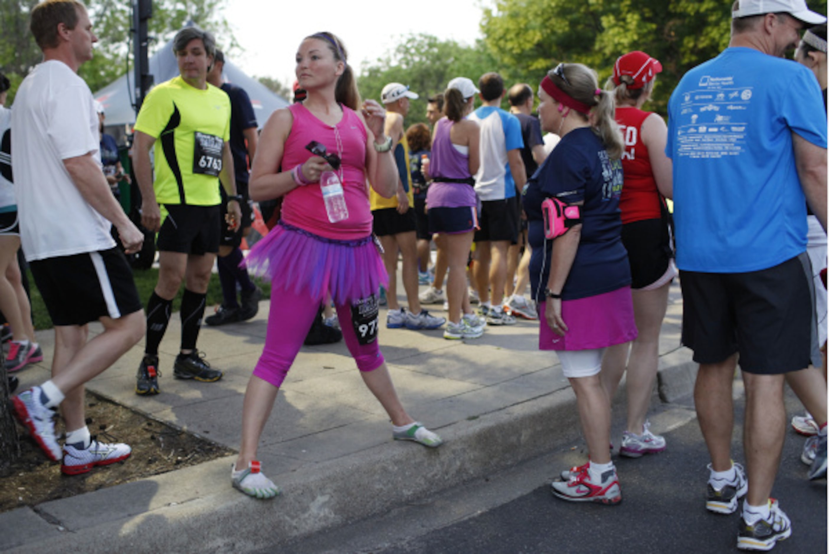 Participants of the Dallas Rock 'N' Roll half marathon stretch before the race begins on...