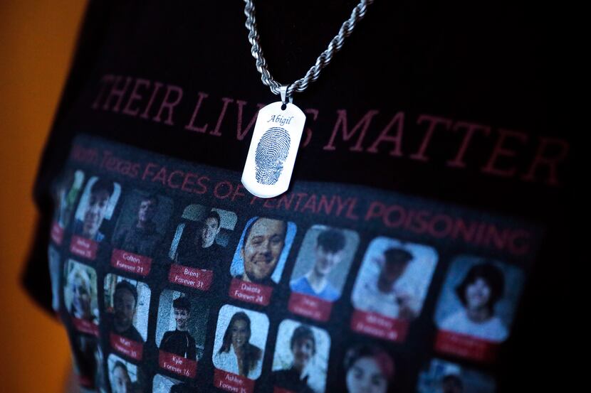Adolph Alvarez wears a dog tag of his daughters fingerprint over a t-shirt representing...