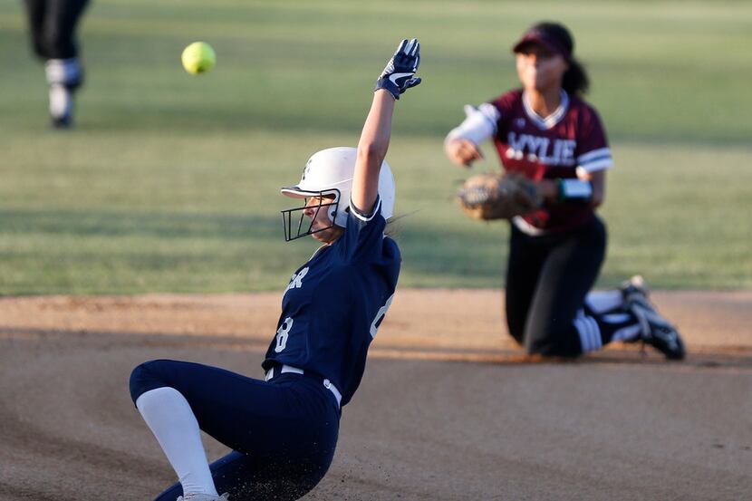 Keller designated player Brooke Davis (8) slides safely into third in front of the throw by...
