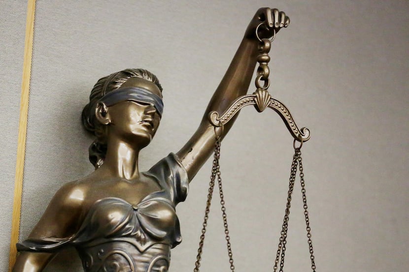 Stock art of a statue of Lady Justice in a courtroom in the Frank Crowley Courts Building in...