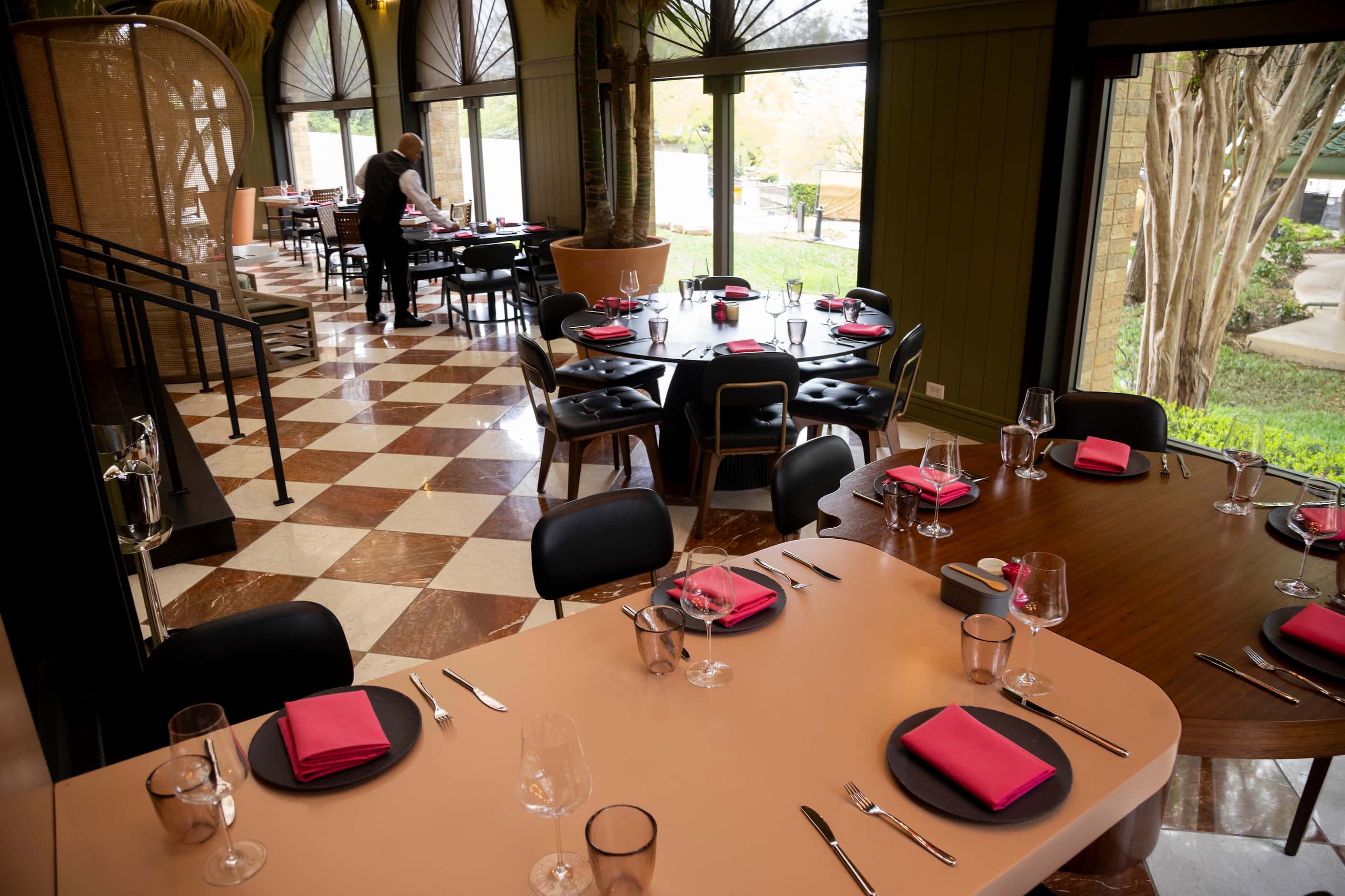 The dining area at Knife Italian is split level. Pink napkins dot the slate-colored plates...