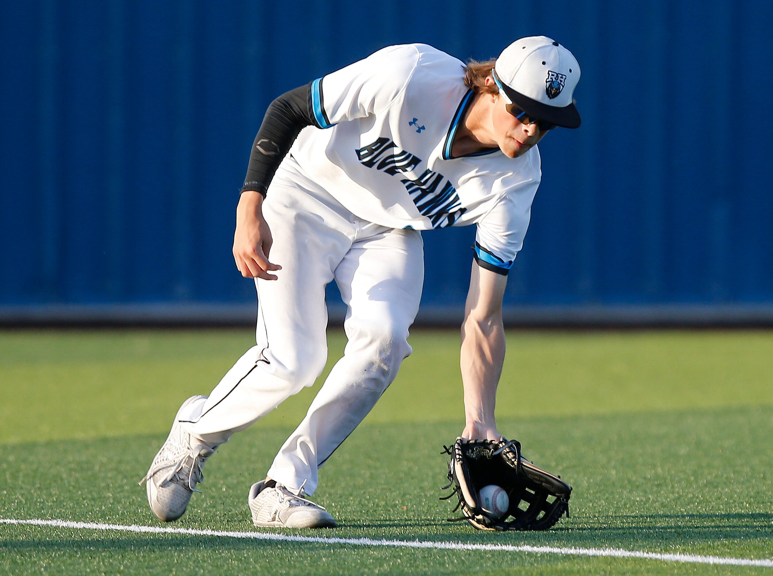 Rock Hill High School left fielder Tyler Powers (2) fields a hit in the second inning as...