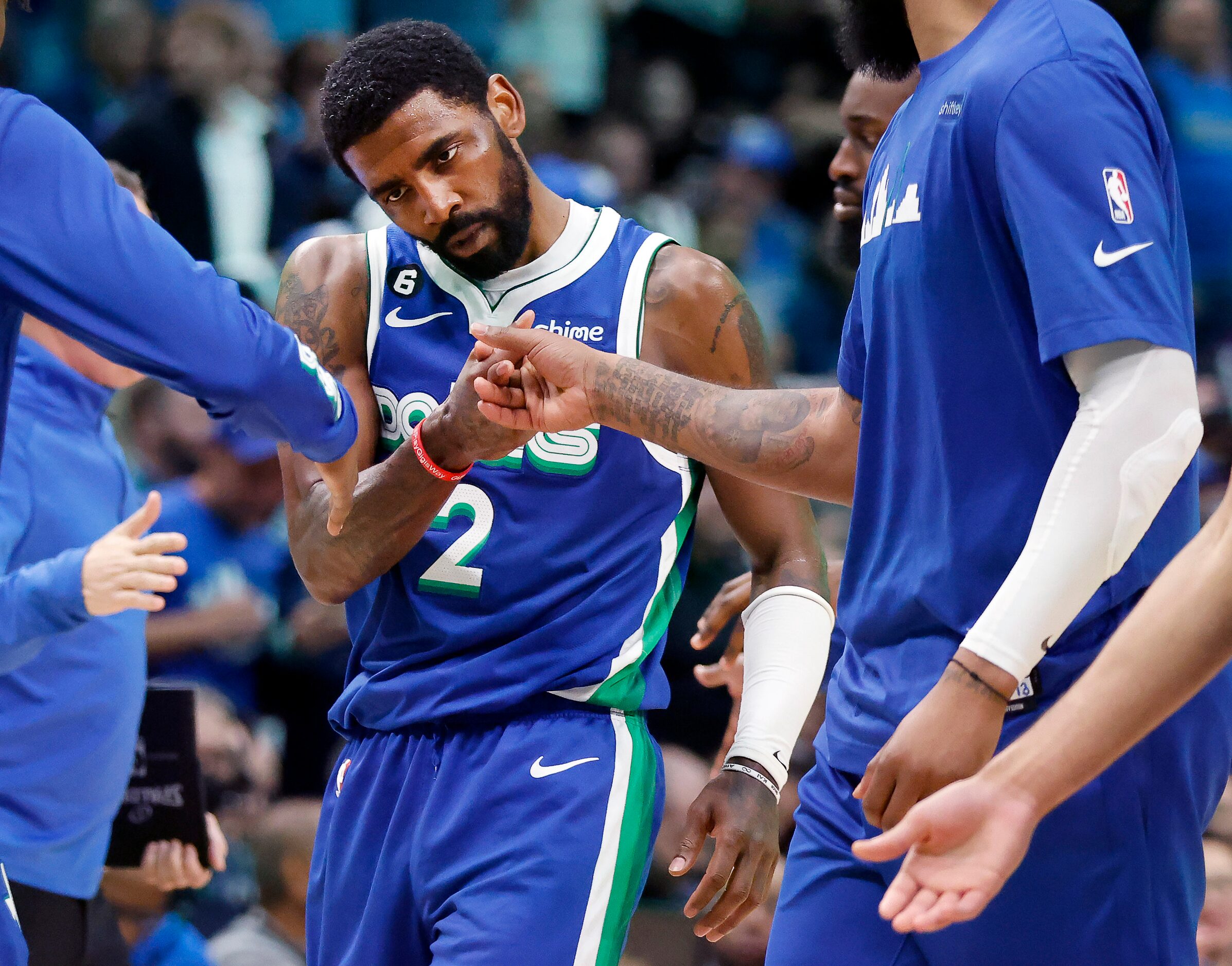 Dallas Mavericks guard Kyrie Irving (2) is congratulated by teammates during a fourth...