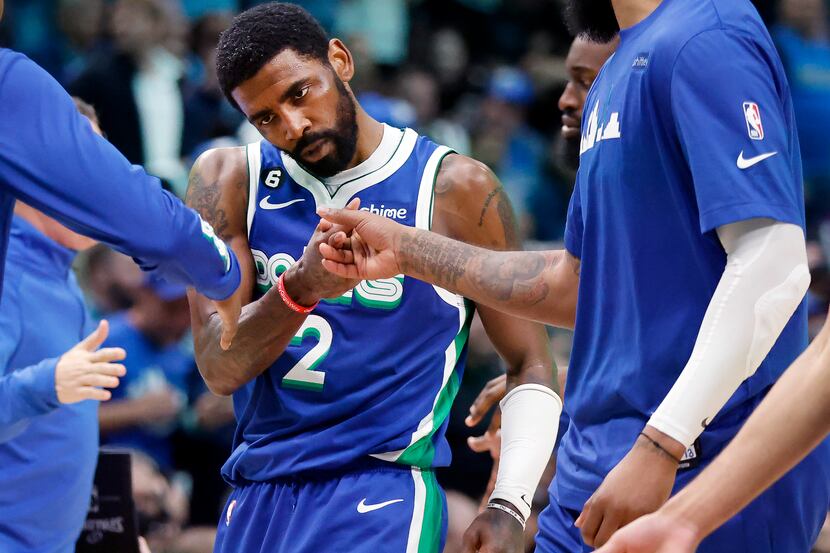 Dallas Mavericks guard Kyrie Irving (2) is congratulated by teammates during a fourth...