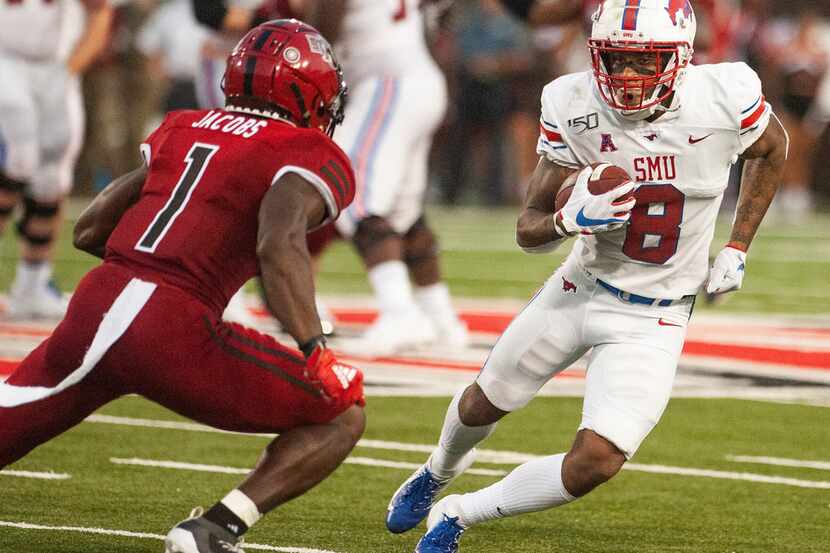 SMU wide receiver Reggie Roberson Jr (8) tries to avoid a tackle attempt by Arkansas State...
