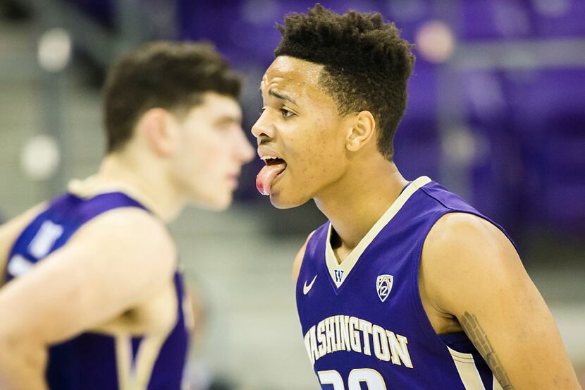 Washington guard Markelle Fultz sticks out his bloodied tongue after taking a hit to the...