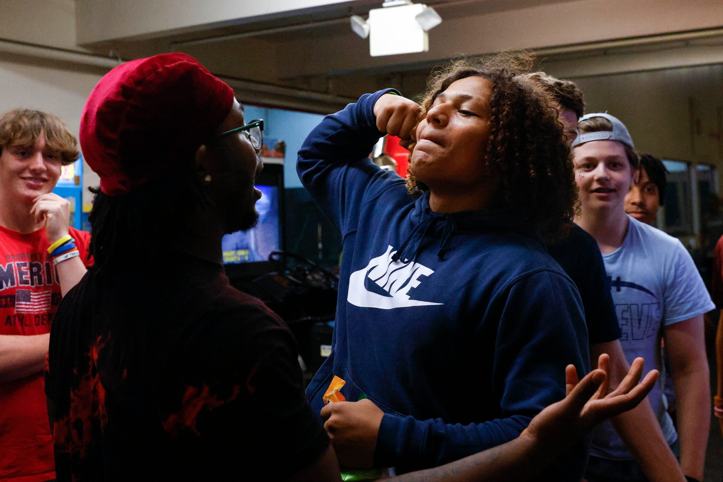 L.D. Bell High School football players Eugene Harris (left) reacts as Caleb Jones flexes...