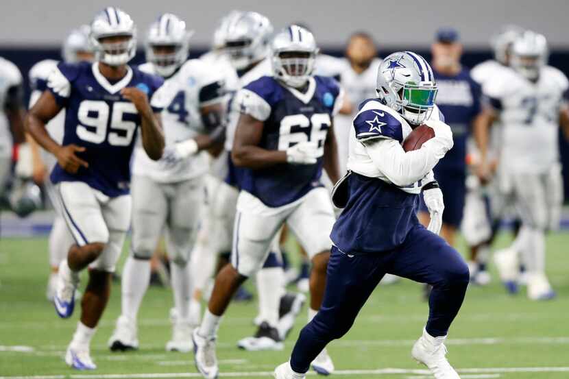 Dallas Cowboys running back Ezekiel Elliott (21) runs up the field on a run play at practice...