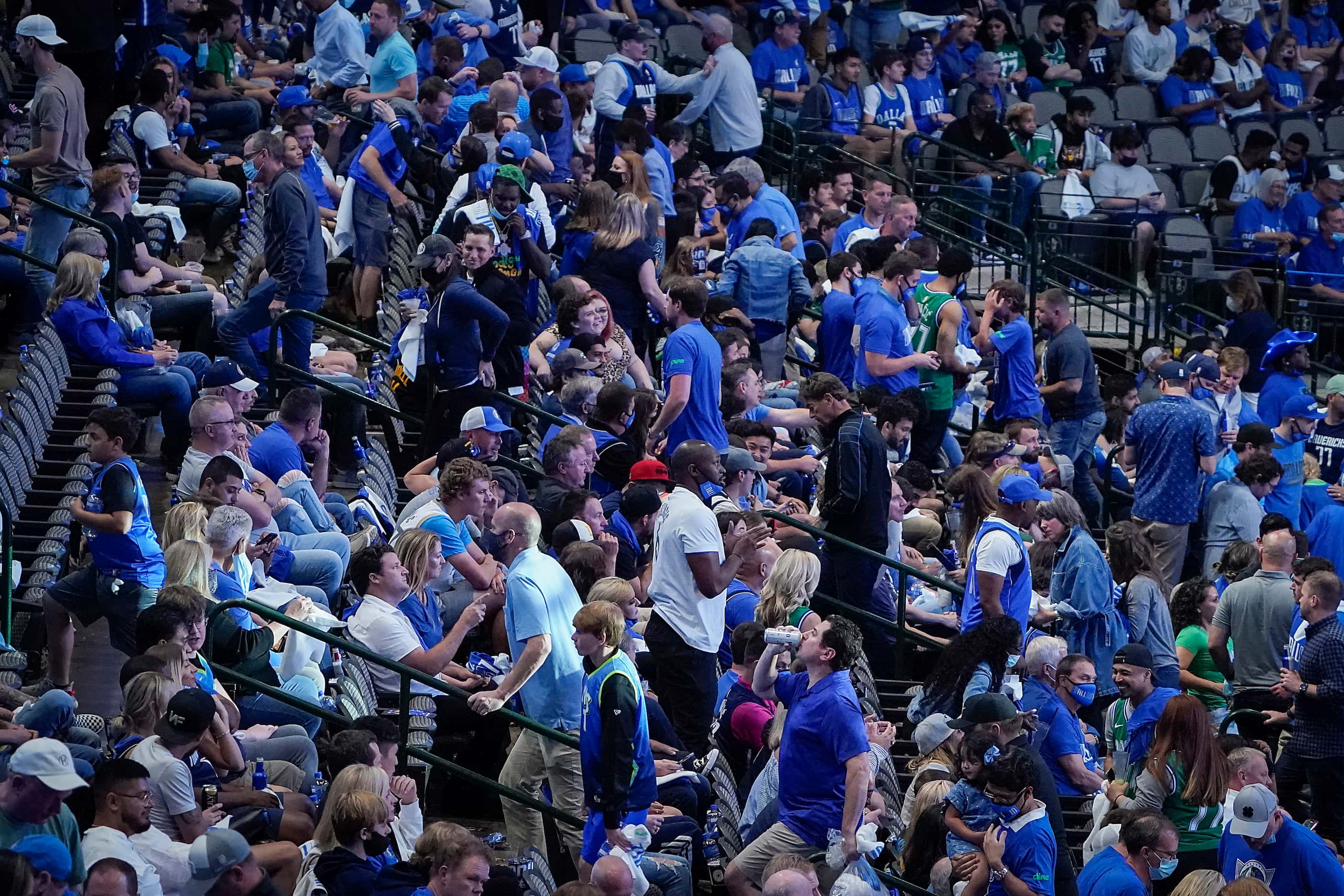 Dallas Mavericks fans head for the exits with just over four minutes left during the fourth...