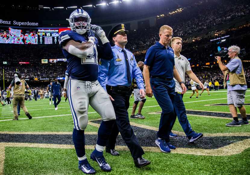 Dallas Cowboys running back Ezekiel Elliott (21) and head coach Jason Garrett leave the...