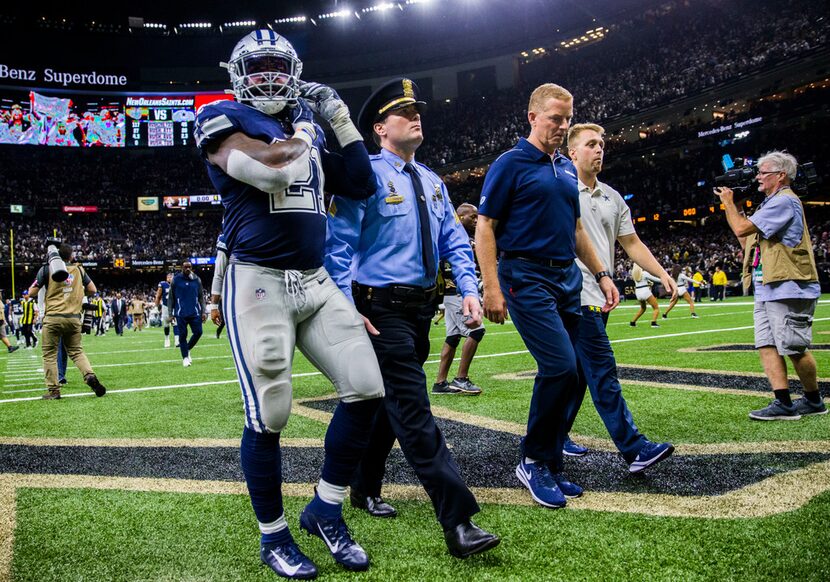 Dallas Cowboys running back Ezekiel Elliott (21) and head coach Jason Garrett leave the...