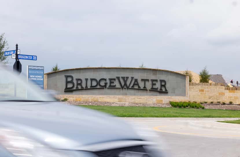 Construction continues behind an entrance sign to BridgeWater, a master-planned community...