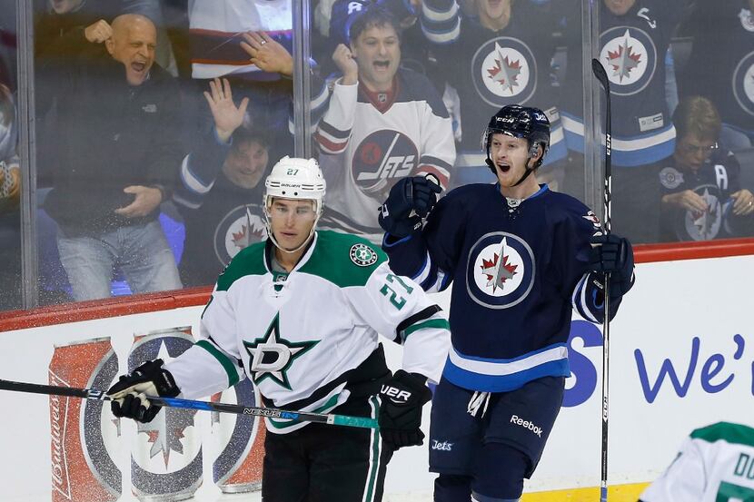 Winnipeg Jets' Kyle Connor (81) celebrates his first NHL goal as Dallas Stars' Adam...