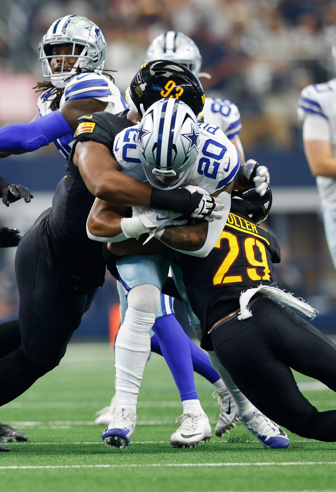 Dallas Cowboys running back Tony Pollard (20) is tackled by Washington Commanders defensive...