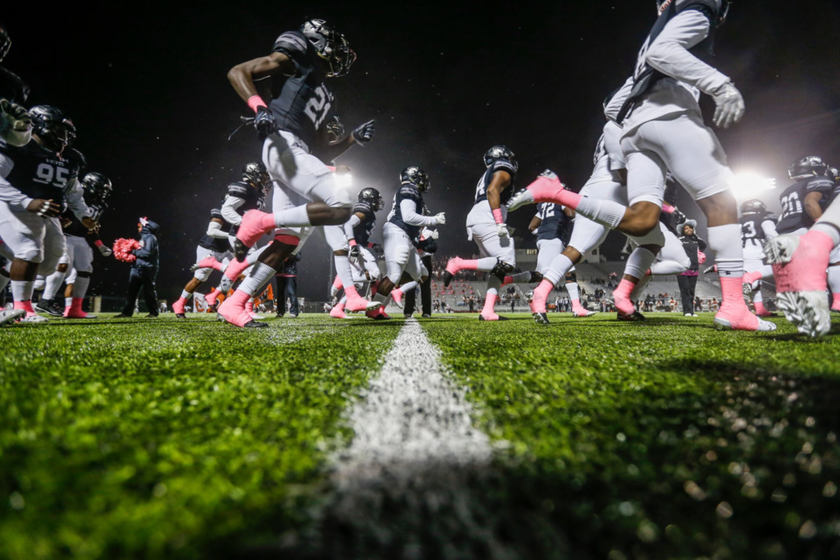 The Mansfield Timberview Wolves break onto the field prior to a high school football matchup...