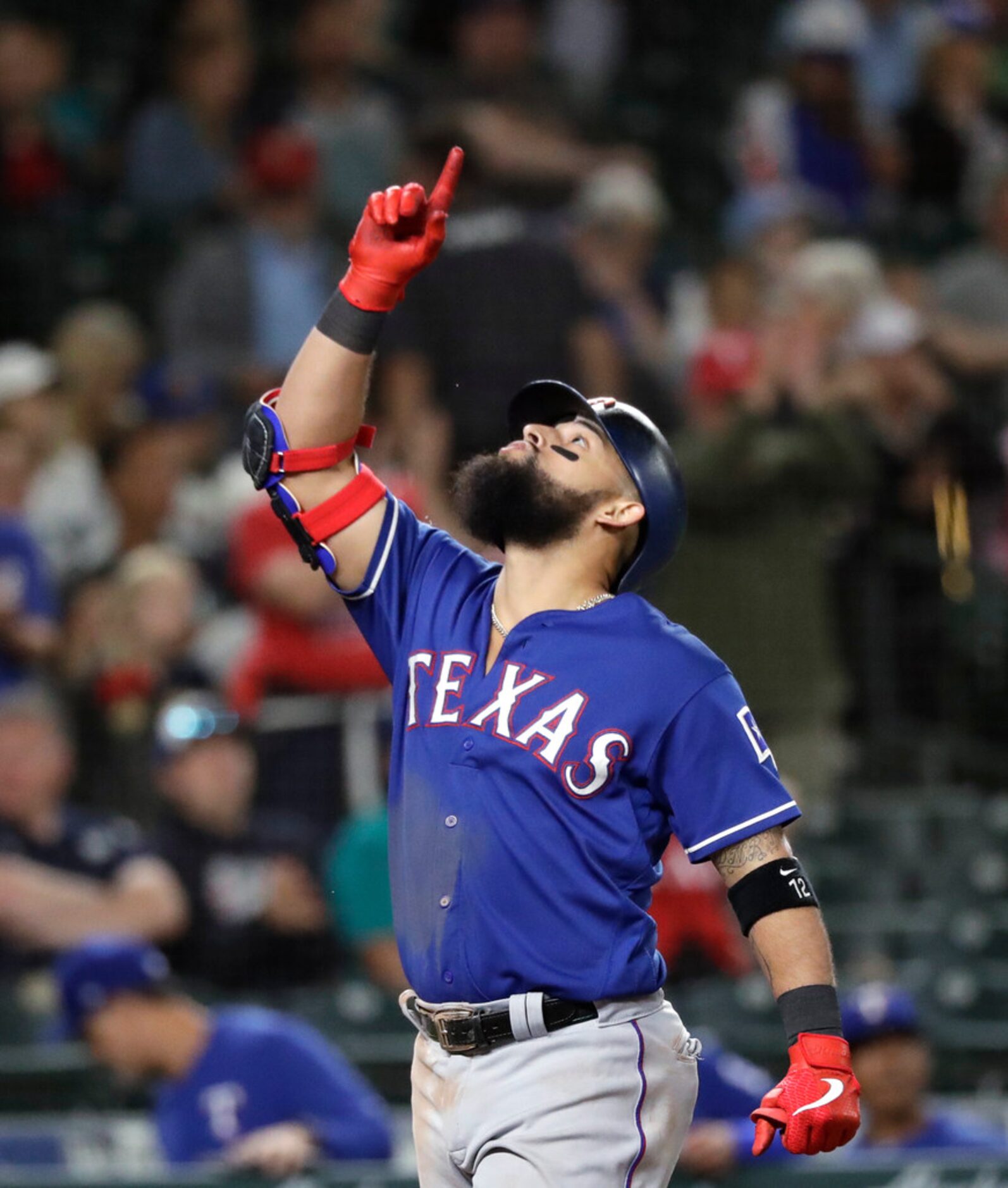 Texas Rangers' Rougned Odor points skyward as he crosses home on his solo home run against...