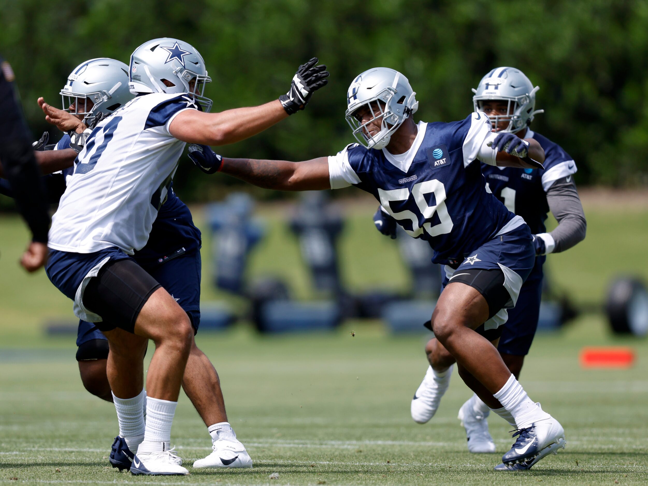 Dallas Cowboys rookie defensive end Chauncey Golston (59) pass rushes during team drills at...