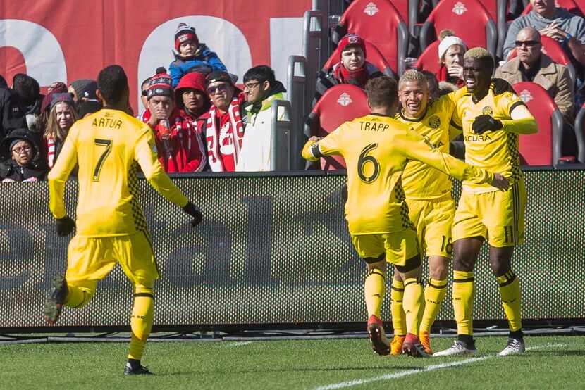 Columbus Crew's Gyasi Zerdes (11) celebrates with Cristian Martinez and Will Trapp (6) after...