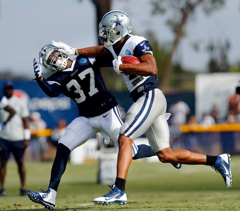 Dallas Cowboys wide receiver Rodney Smith (14) gives defensive back Jeremiah McKinnon (37) a...