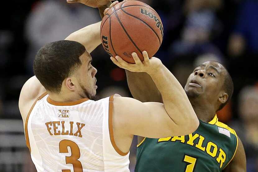 Baylor's Kenny Chery (1) tries to block a shot by Texas' Javan Felix (3) during the first...