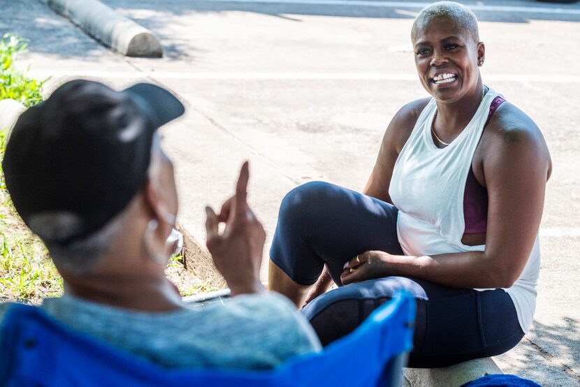 Kyna Bradford, 44 (right), visits in between rounds of a softball tournament at Kiest Park.