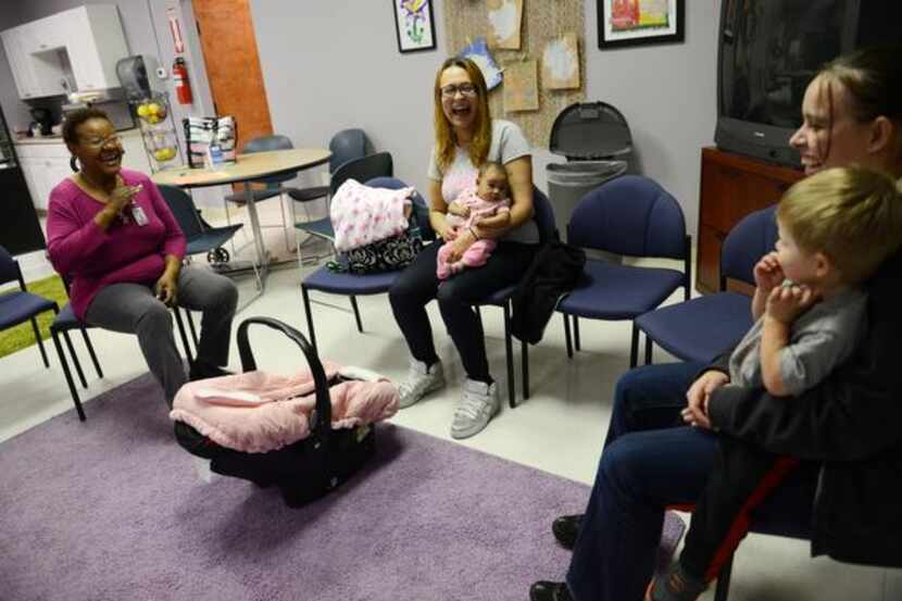 
Child specialist Catherine Wright (right) talks to Tracy Germait (middle), Sara Kendall and...