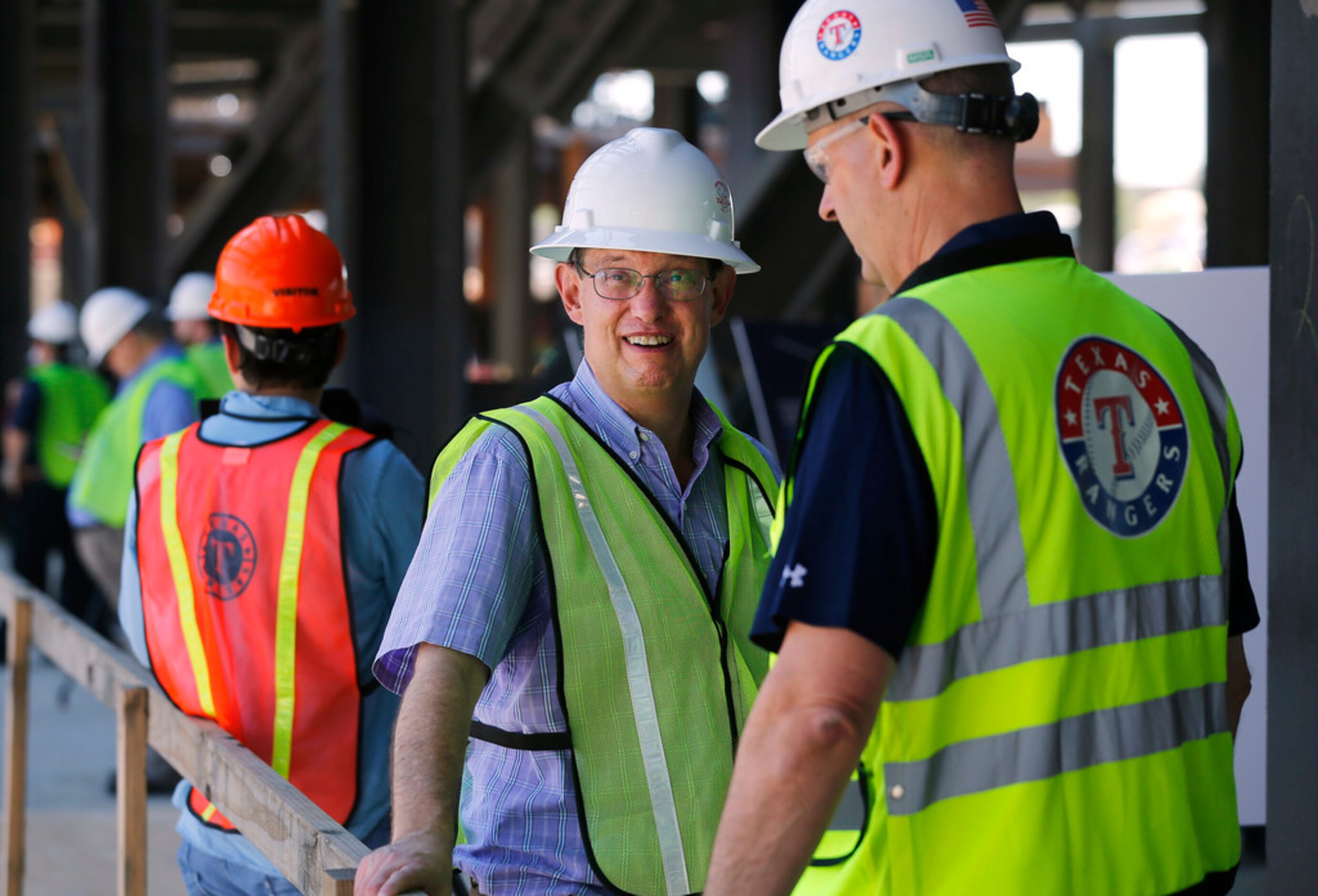 Texas Rangers Executive Vice President of Communications John Blake (center) is pictured at...