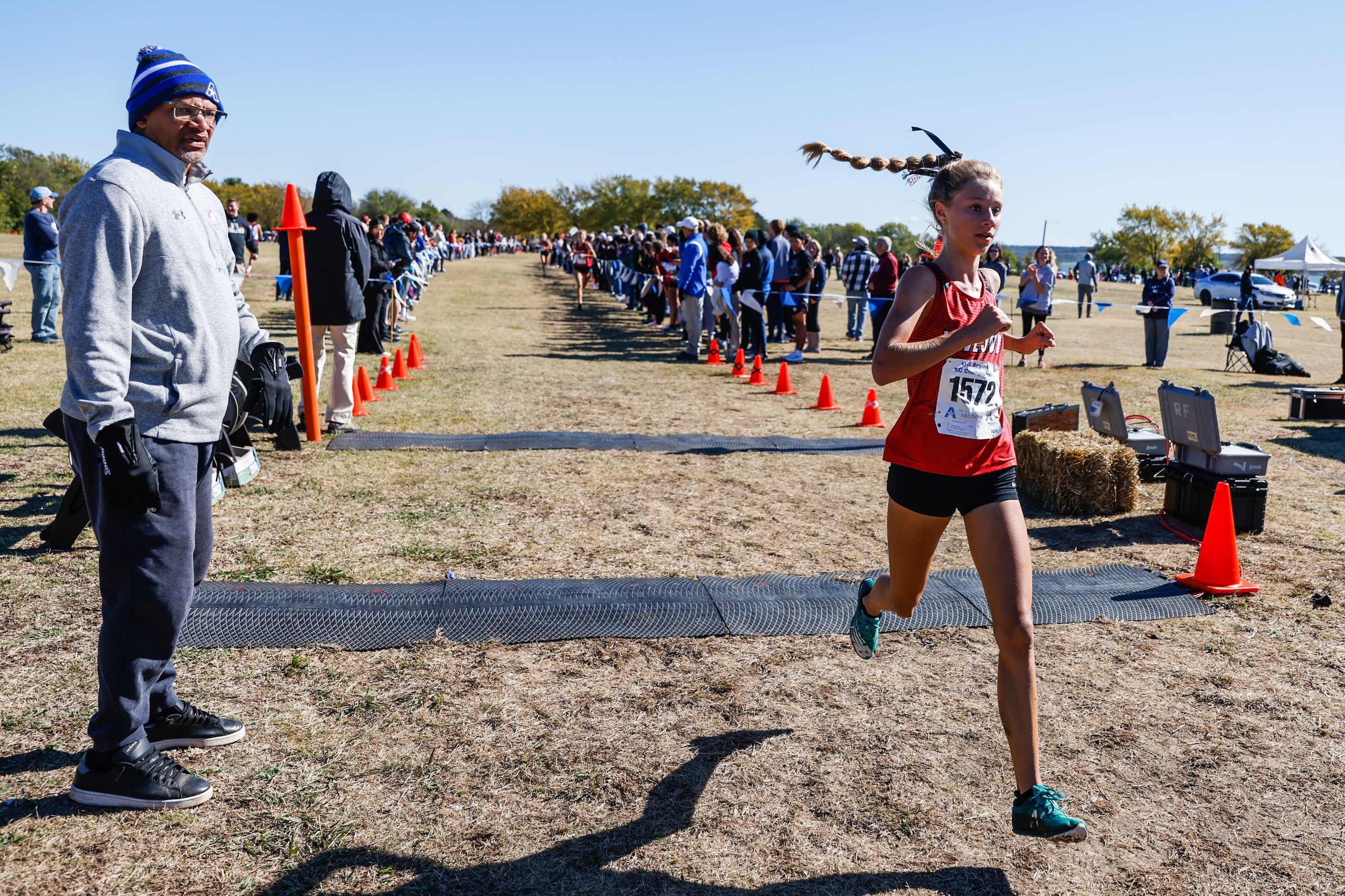 Camryn Benson (1572) from Lucas Lovejoy team crosses the finish line fourth during the Class...