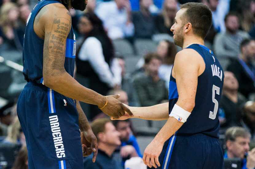 Dallas Mavericks center DeAndre Jordan (6) shakes hands with guard J.J. Barea (5) during the...