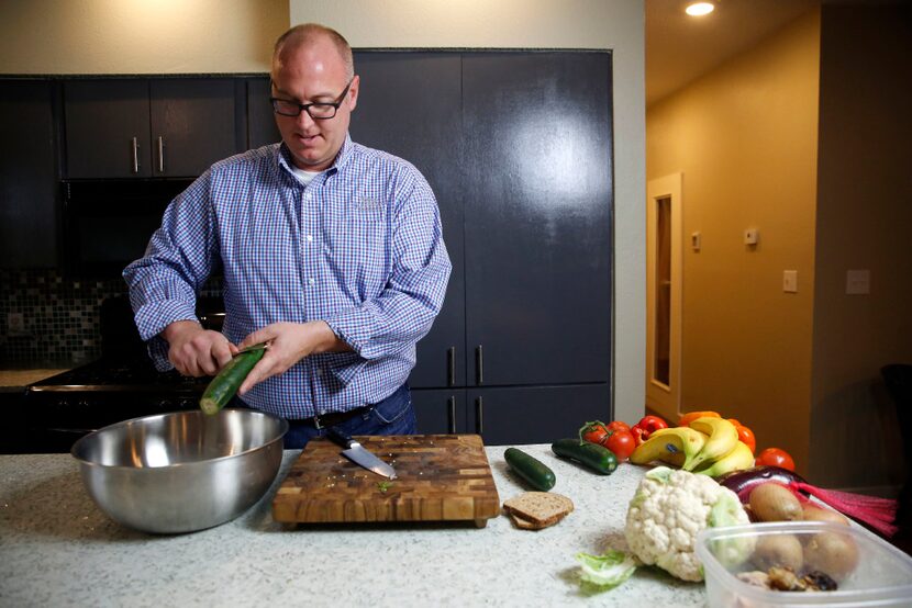 Horticulturalist Daniel Cunningham prepares food scraps to make compost inside a bokashi...