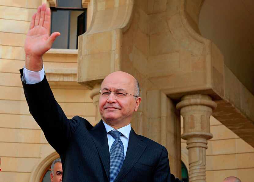 In this Oct. 11, 2018 file photo, Iraqi President Barham Salih waves goodbye to Turkish...