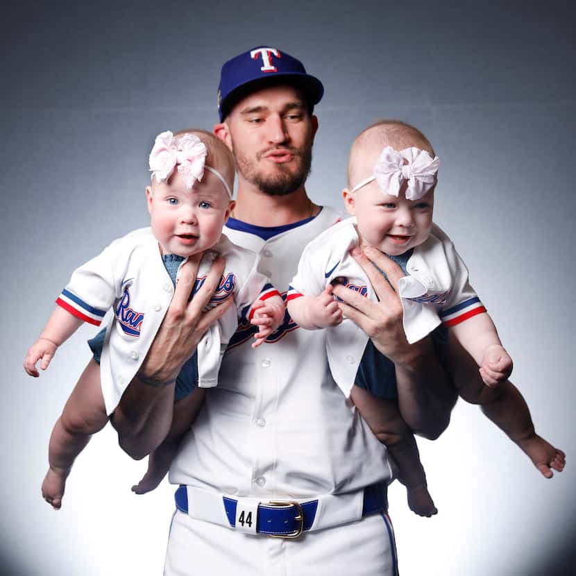 Texas Rangers Andrew Heaney pictured with his twin daughters Eleanor (right) and Olivia at...
