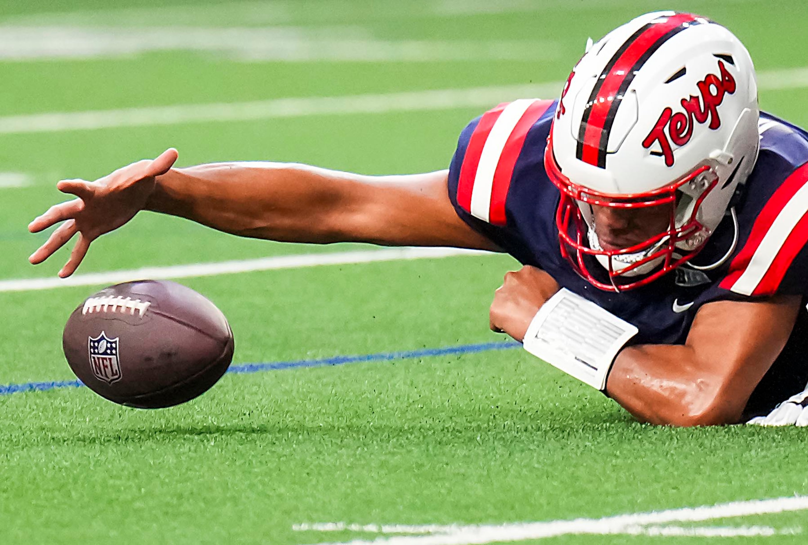 West quarterback Taulia Tagovailoa of Maryland  (5) recovers a fumbled snap during the first...