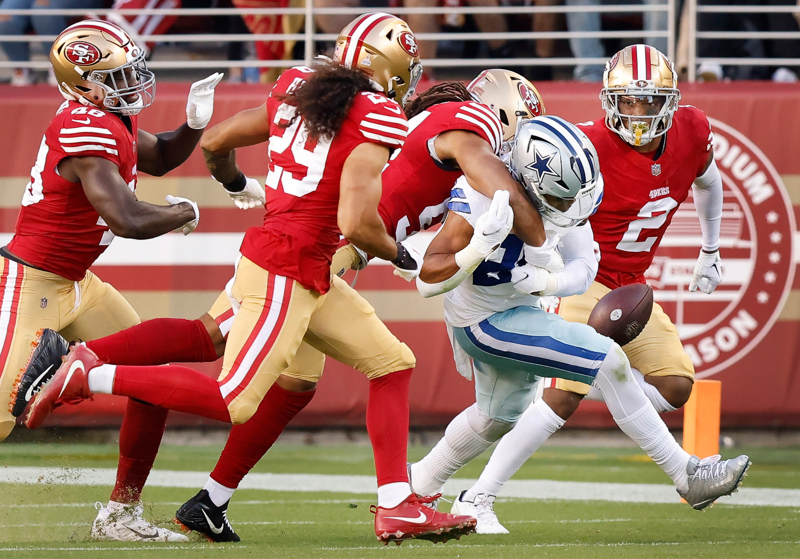 Dallas Cowboys running back Tony Pollard (20) fumbles the ball after being hit by San...