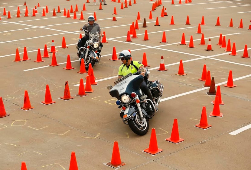  Motorcycle officers James Alexander (front) of North Richland Hills and Rogan Alan of the...