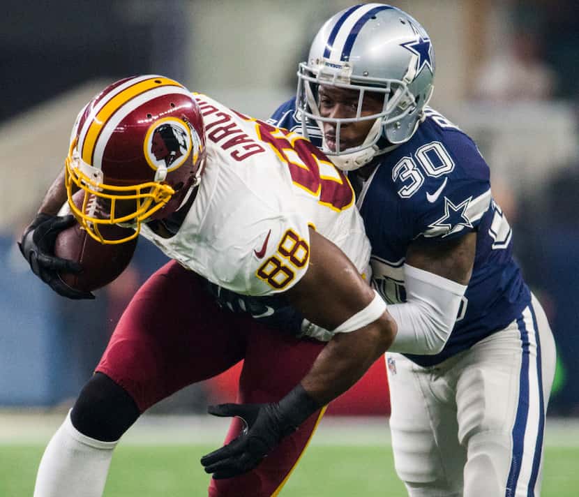 Dallas Cowboys cornerback Anthony Brown (30) tackles Washington Redskins wide receiver...