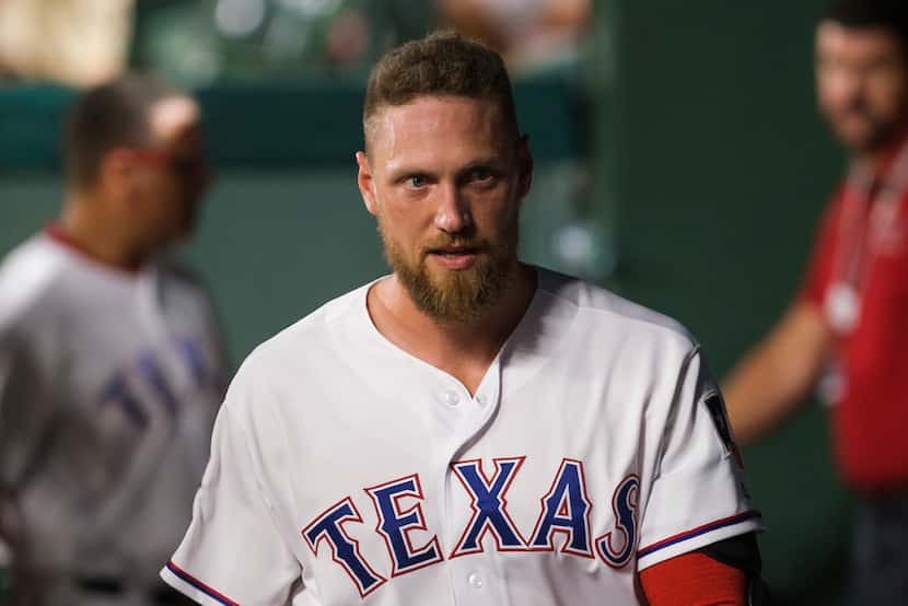 FILE - Rangers pinch hitter Hunter Pence is pictured in the dugout after batting in the...
