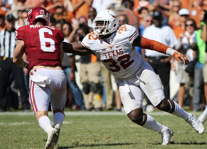 FILE - Texas Longhorns linebacker Malcolm Roach (32) puts pressure on Oklahoma Sooners...