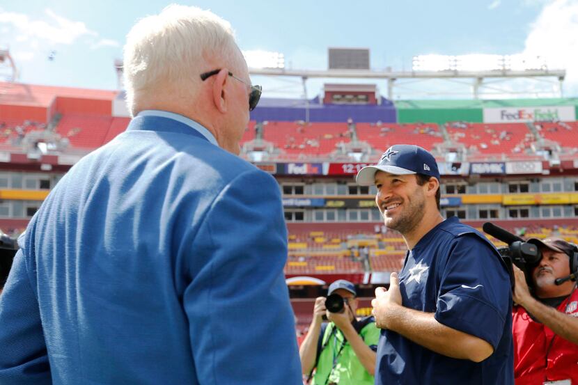 Dallas Cowboys owner and general manager Jerry Jones talks with Dallas Cowboys quarterback...